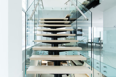 Design ideas for a large modern wood l-shaped staircase in Toronto with open risers.