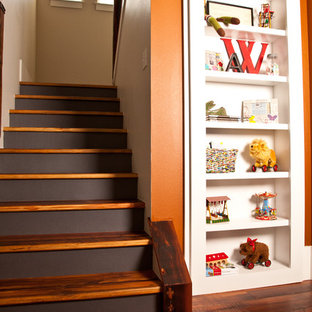 Elegant wooden staircase photo in Denver with painted risers