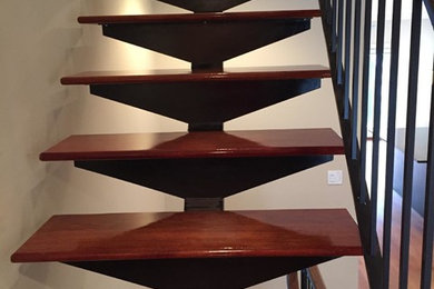 Design ideas for a medium sized modern wood straight staircase in Chicago with open risers.