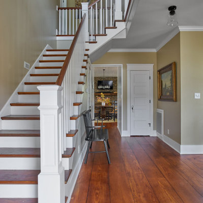 Example of a mid-sized cottage wooden l-shaped wood railing staircase design in Other with painted risers