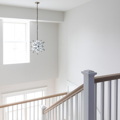 Large farmhouse carpeted u-shaped wood railing staircase photo in Chicago with carpeted risers