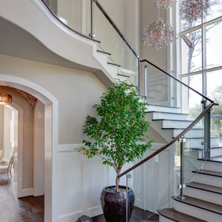 Inspiration for a transitional wooden glass railing staircase remodel in Houston with painted risers