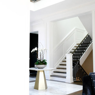 Réalisation d'un grand escalier asiatique en U avec des marches en bois, un garde-corps en métal et boiseries.