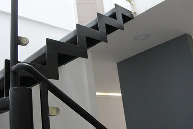 Medium sized contemporary metal floating staircase in London with metal risers.