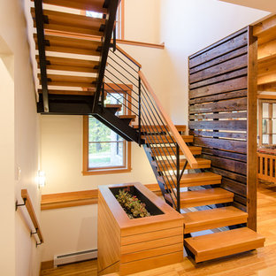 Large country wooden u-shaped open staircase photo in Burlington