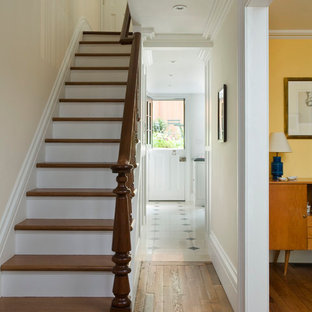 Inspiration for a mid-sized timeless wooden straight staircase remodel in New York with wooden risers