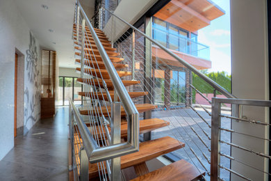 Diseño de escalera recta actual grande sin contrahuella con escalones de madera