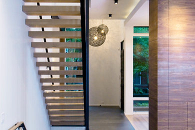 Inspiration for a mid-sized industrial wooden straight open and metal railing staircase remodel in Chicago