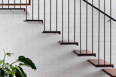 Contemporary wood floating metal railing staircase in Melbourne with metal risers.