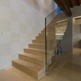 Foto di una scala sospesa country di medie dimensioni con pedata in travertino, alzata in travertino e parapetto in vetro