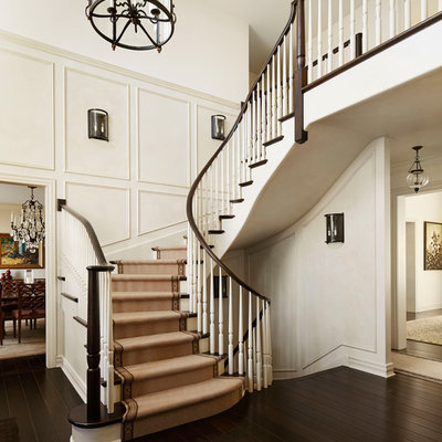 Staircase - traditional wooden curved staircase idea in Milwaukee
