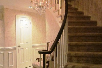 Mid-sized elegant carpeted curved staircase photo in Other with carpeted risers