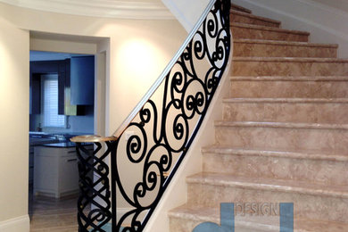 Design ideas for a large modern curved metal railing staircase in Toronto with marble treads and marble risers.