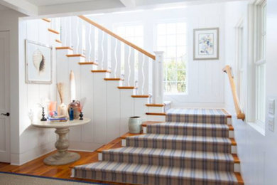 Medium sized country wood l-shaped wood railing staircase in DC Metro with painted wood risers.
