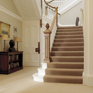 Idee per un'ampia scala a "U" classica con pedata in legno verniciato e alzata in legno verniciato