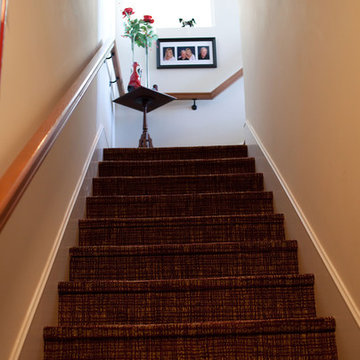 Carpet staircase leading up to a 2nd floor master suite