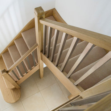 Carpeted Staircase with Stainless Steel Spindles