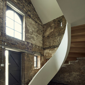 Cast concrete ribbon staircase in the entrance hall of the Coach House