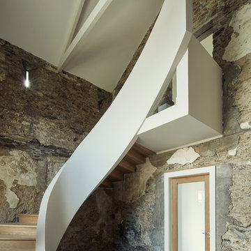 Cast concrete ribbon staircase in the entrance hall of the Coach House