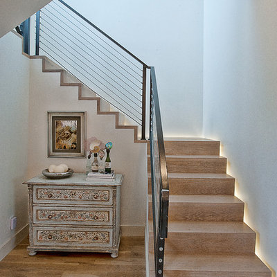 Transitional wooden cable railing staircase photo in Austin with wooden risers