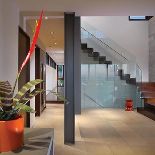 Minimalist wooden l-shaped glass railing staircase photo in Orange County with wooden risers