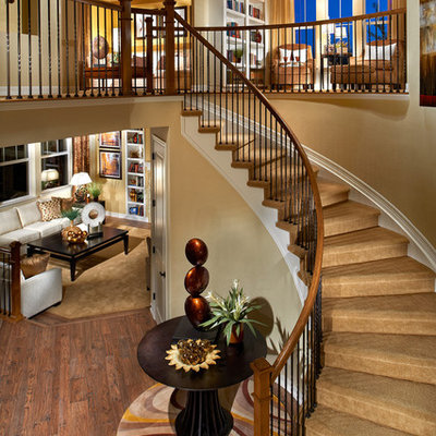 Elegant carpeted curved staircase photo in Denver with carpeted risers