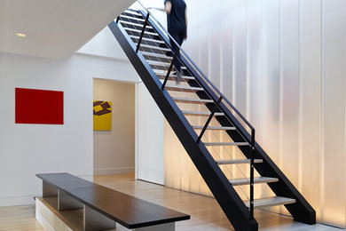 Photo of a contemporary straight wire cable railing staircase in New York with open risers.