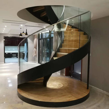Circular villa staircase with round glass railing