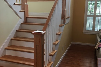 Example of a mid-sized arts and crafts wooden u-shaped wood railing staircase design in Seattle with painted risers