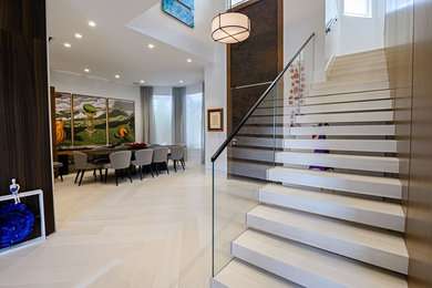 Inspiration for a medium sized modern wood l-shaped glass railing staircase in Tampa with open risers.
