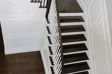 Large transitional painted wood railing staircase photo in New York with painted risers