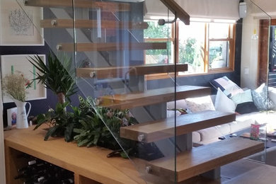 Moderne Holztreppe in L-Form mit offenen Setzstufen in Sydney