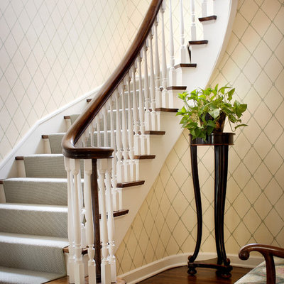Elegant wooden curved wood railing staircase photo in Chicago with wooden risers