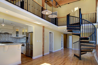Inspiration for a large contemporary wooden spiral metal railing staircase remodel in Providence with metal risers