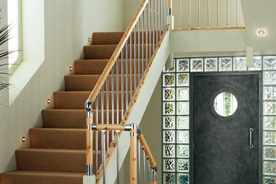 Photo of a medium sized contemporary straight staircase in Other.