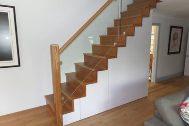 Design ideas for a medium sized contemporary wood l-shaped staircase in London with wood risers.