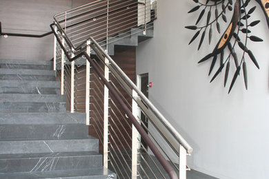 Large trendy concrete l-shaped cable railing staircase photo in San Diego with concrete risers