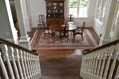 Example of a farmhouse wooden l-shaped wood railing staircase design in Raleigh with painted risers