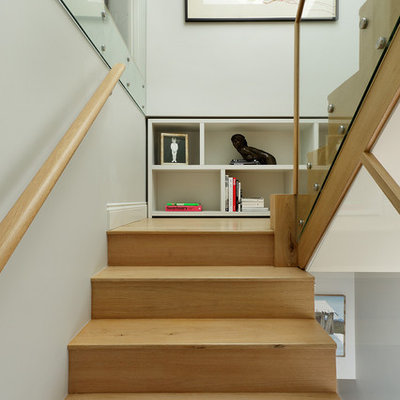 Example of a trendy wooden u-shaped staircase design in London with wooden risers
