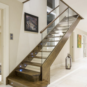 Contemporary Staircase featuring Glass and Lighting