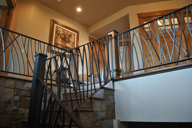 Mid-sized mountain style wooden l-shaped metal railing staircase photo in Denver with wooden risers