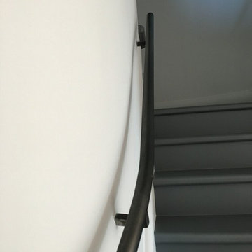 Contemporary vertical angled steel cable railing