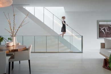 Example of a large minimalist wooden straight open staircase design in San Francisco