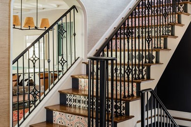 Example of an eclectic wooden u-shaped metal railing staircase design in Boston with tile risers