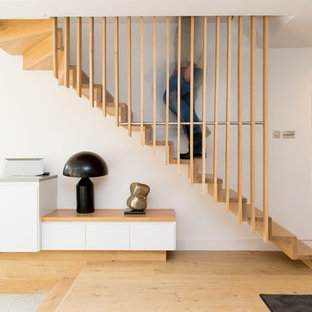 Inspiration for a scandinavian wooden l-shaped staircase remodel in London with wooden risers