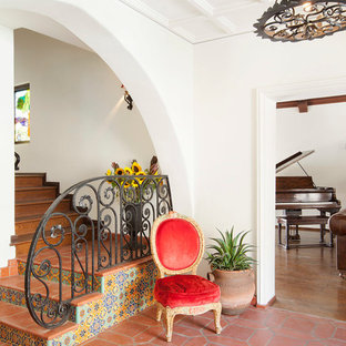 Mediterrane Treppe in L-Form mit gefliesten Setzstufen, Terrakotta-Treppenstufen und Stahlgeländer in Los Angeles