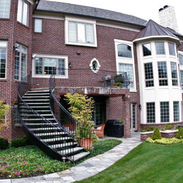 Curved Exterior Staircase with Wrought Iron Balcony Rail