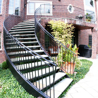 Curved Exterior Staircase with Wrought Iron Balcony Rail