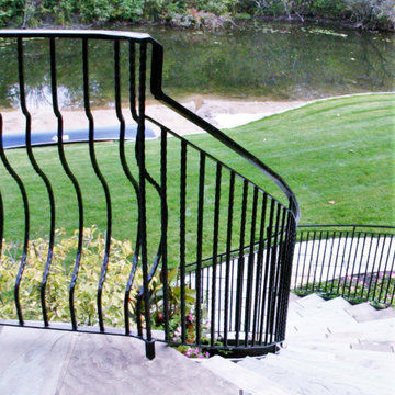 Curved Exterior Staircase with Wrought Iron Balcony Rail