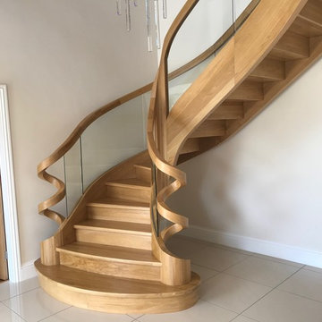 Curved Oak stairs with a roller coaster handrails